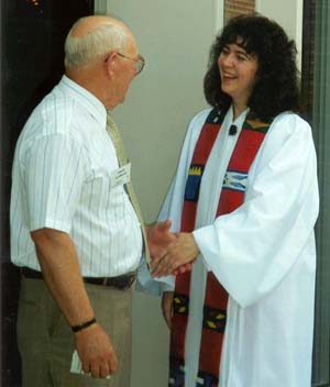 Pastor Anne greeting St. John's Congregation member